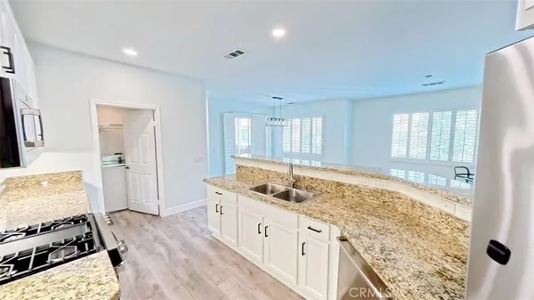 a spacious bathroom with a granite countertop sink and a large mirror