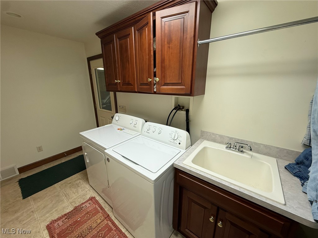 2597 Pyle Road Dover, OH 44622 - Photo 24 of 50 Laundry area with cabinet space and washer and clothes dryer