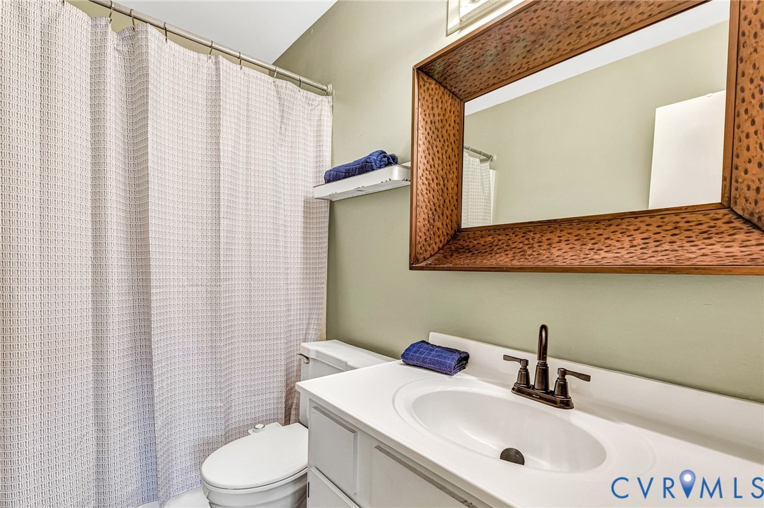 11713 South Briar Patch Drive Midlothian, VA 23113 - Photo 15 of 23 a bathroom with a sink a toilet and mirror