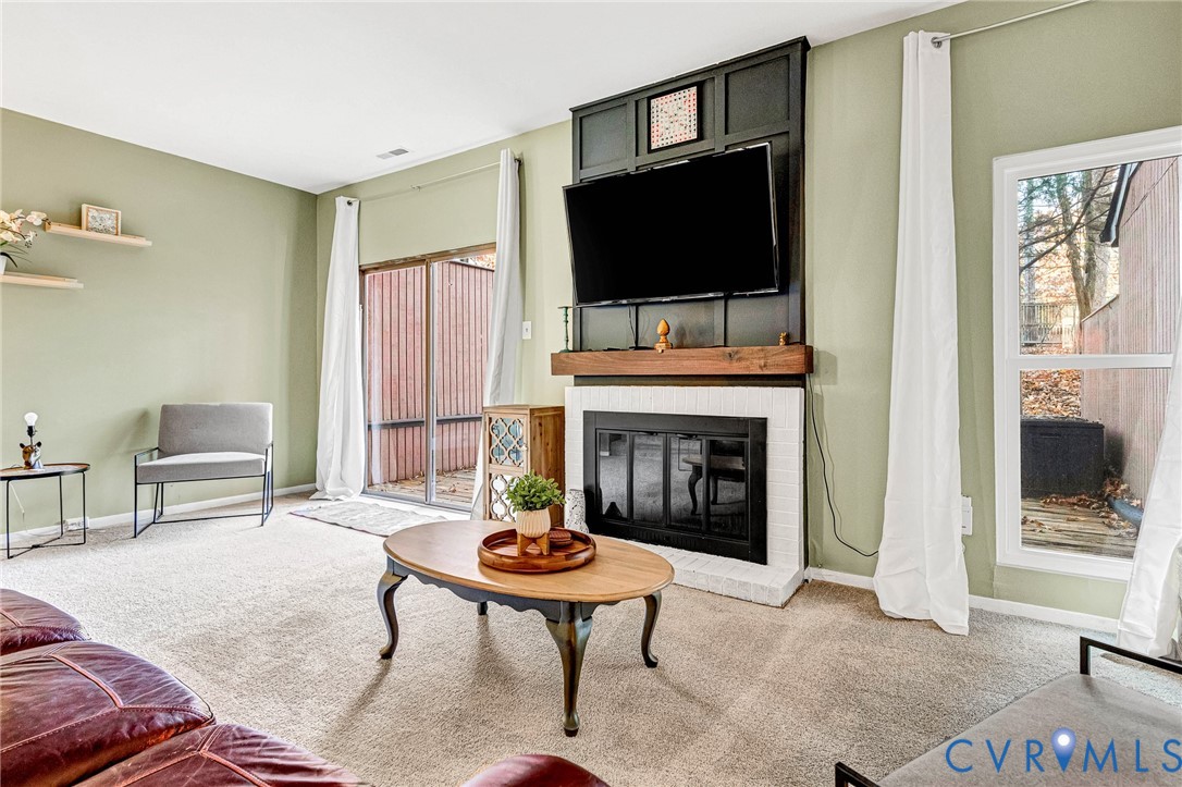 11713 South Briar Patch Drive Midlothian, VA 23113 - Photo 10 of 23 a living room with furniture a flat screen tv and a fireplace