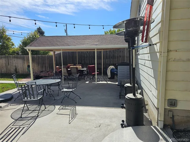 a patio with table and chairs