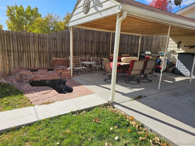 a view of a patio with a table and chairs