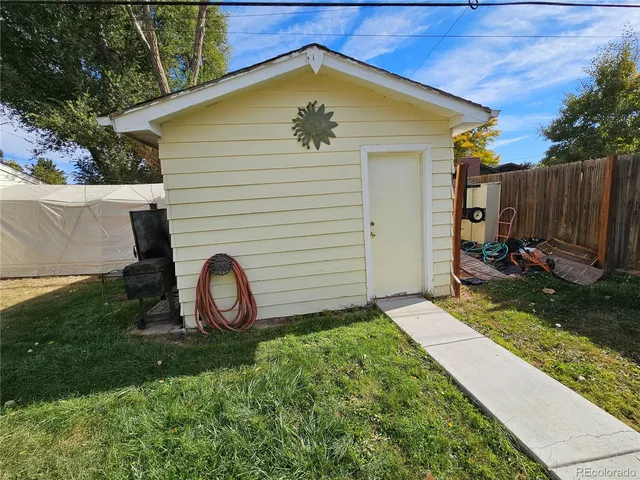 a view of a backyard with plants and a slide