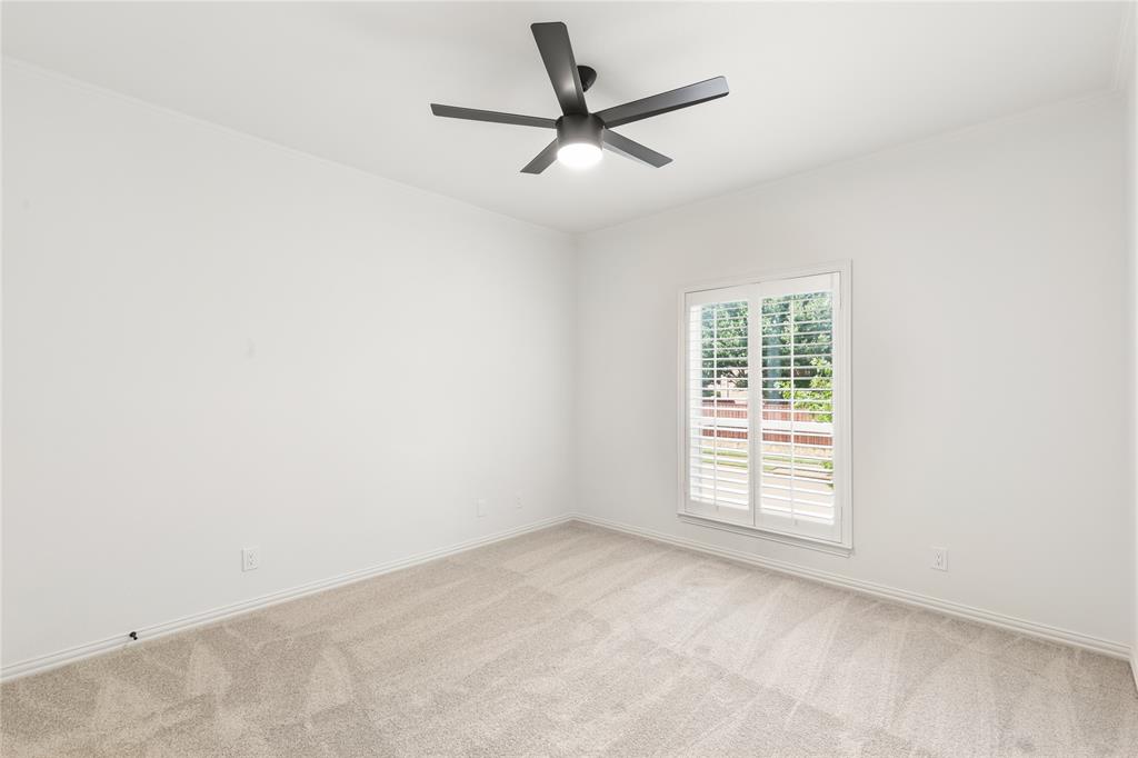 967 East Bethel School Road Coppell, TX 75019 - Photo 33 of 39 Neutral-toned carpeted room featuring a modern ceiling fan with integrated lighting