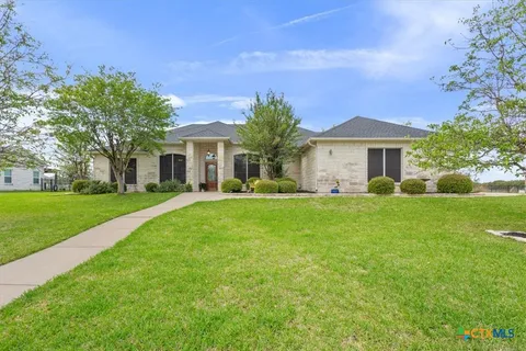 a front view of house with yard and green space