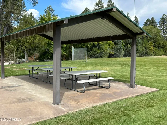 a backyard of a house with wooden floor table and chairs