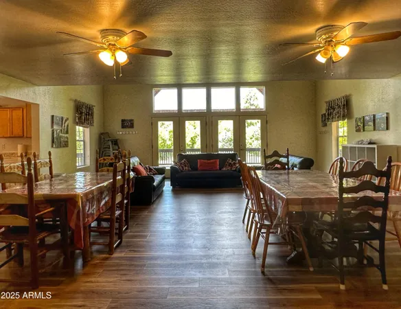 a view of a dining room with furniture and chandelier