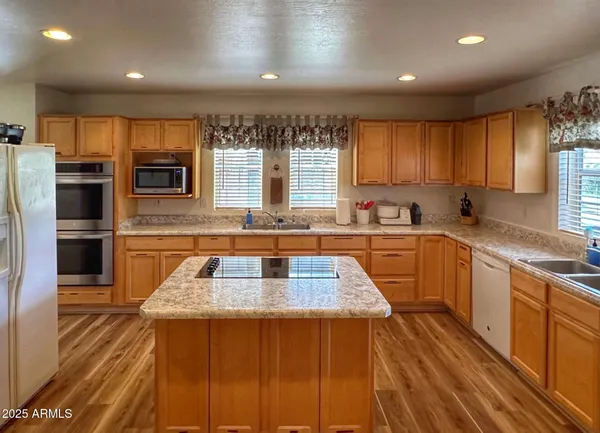 a kitchen with stainless steel appliances granite countertop a sink stove and cabinets