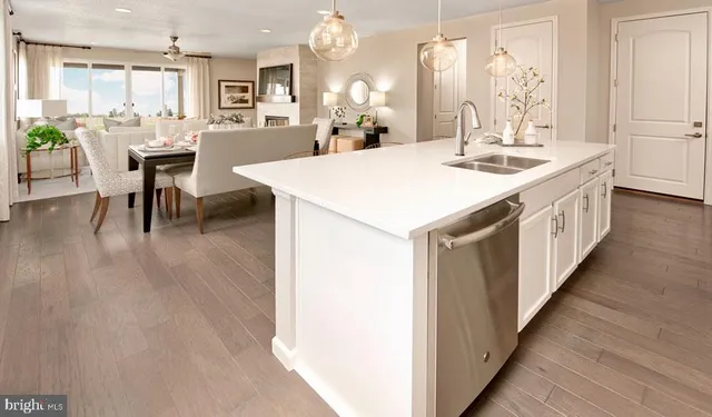 a kitchen with a dining table chairs and white cabinets