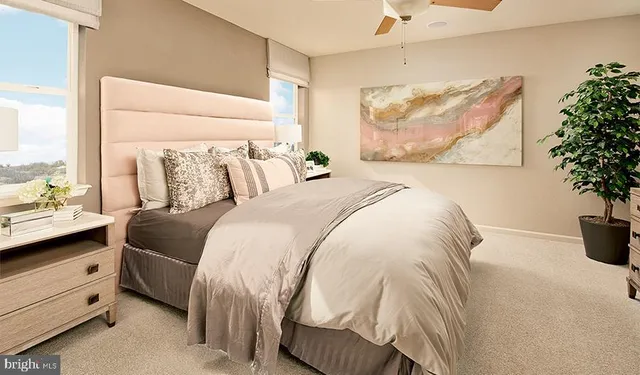 a bed with a white comforter and pillows