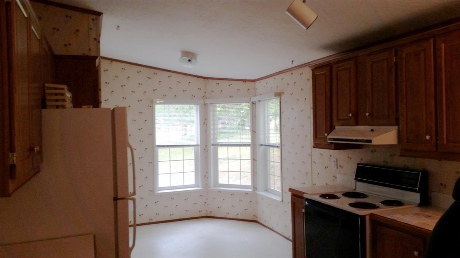 511 Donet Lane Merlin, OR 97532 - Photo 6 of 29 a kitchen with granite countertop a stove and a refrigerator