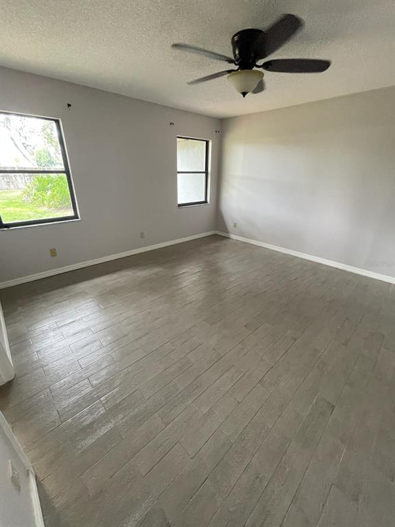 1427 Chamberlain Loop Lake Wales, FL 33853 - Photo 5 of 7 en empty room with windows and ceiling fan