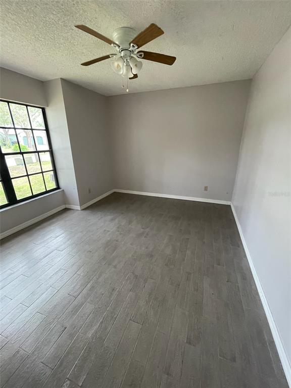 1427 Chamberlain Loop Lake Wales, FL 33853 - Photo 7 of 7 wooden floor in an empty room with a window