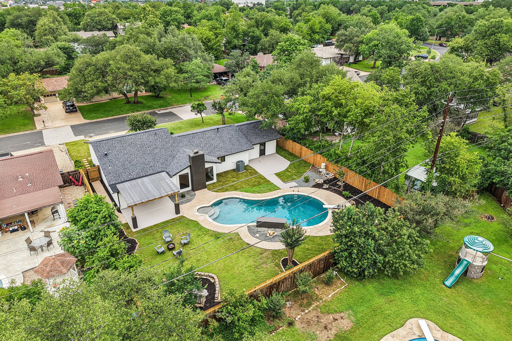 11809 Charing Cross Road Austin, TX 78759 - Photo 30 of 34 An inviting backyard oasis awaits with a custom-shaped swimming pool and ample green space.