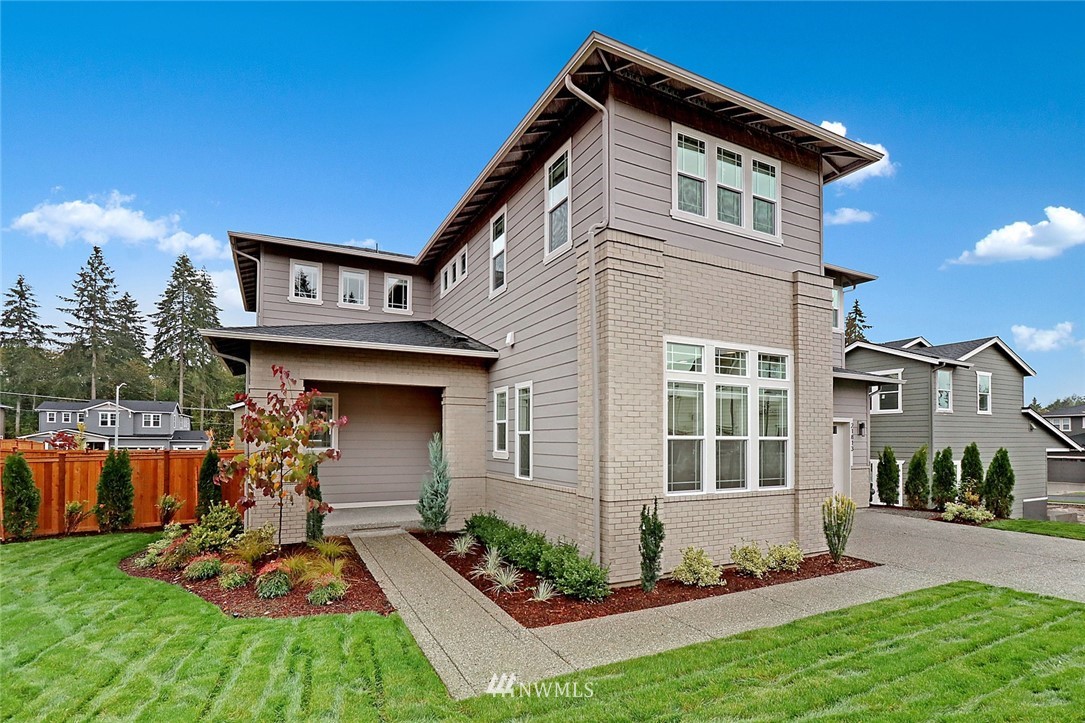 21813 33rd Drive Southeast, Unit 36 Bothell, WA 98021 - Photo 1 of 22 a front view of a house with garden