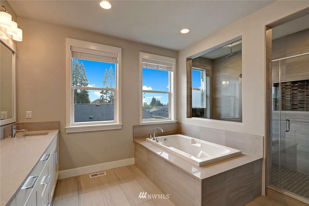 21813 33rd Drive Southeast, Unit 36 Bothell, WA 98021 - Photo 14 of 22 a bathroom with a sink a vanity and a bathtub