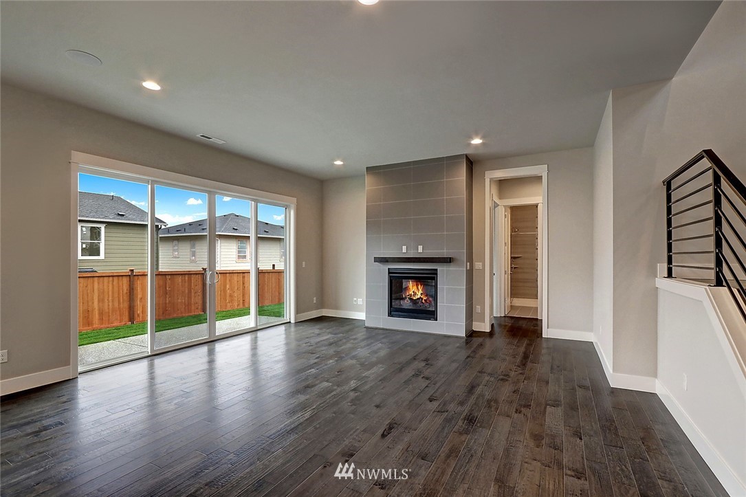 21813 33rd Drive Southeast, Unit 36 Bothell, WA 98021 - Photo 7 of 22 an empty room with wooden floor and fireplace