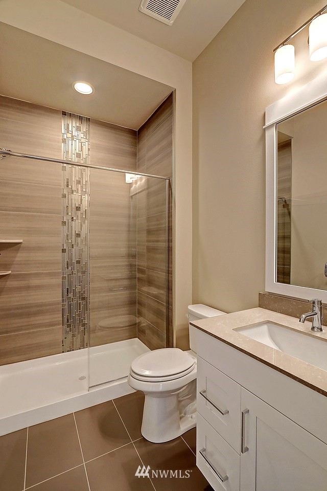 21813 33rd Drive Southeast, Unit 36 Bothell, WA 98021 - Photo 9 of 22 a bathroom with a toilet a sink and shower