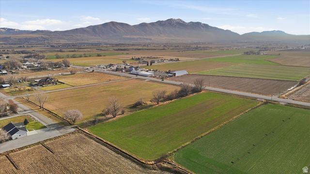 5601 West 15200 North Riverside, UT 84334 - Photo 8 of 10 Aerial overview of property's location featuring farmland, rural landscape, and a mountain backdrop