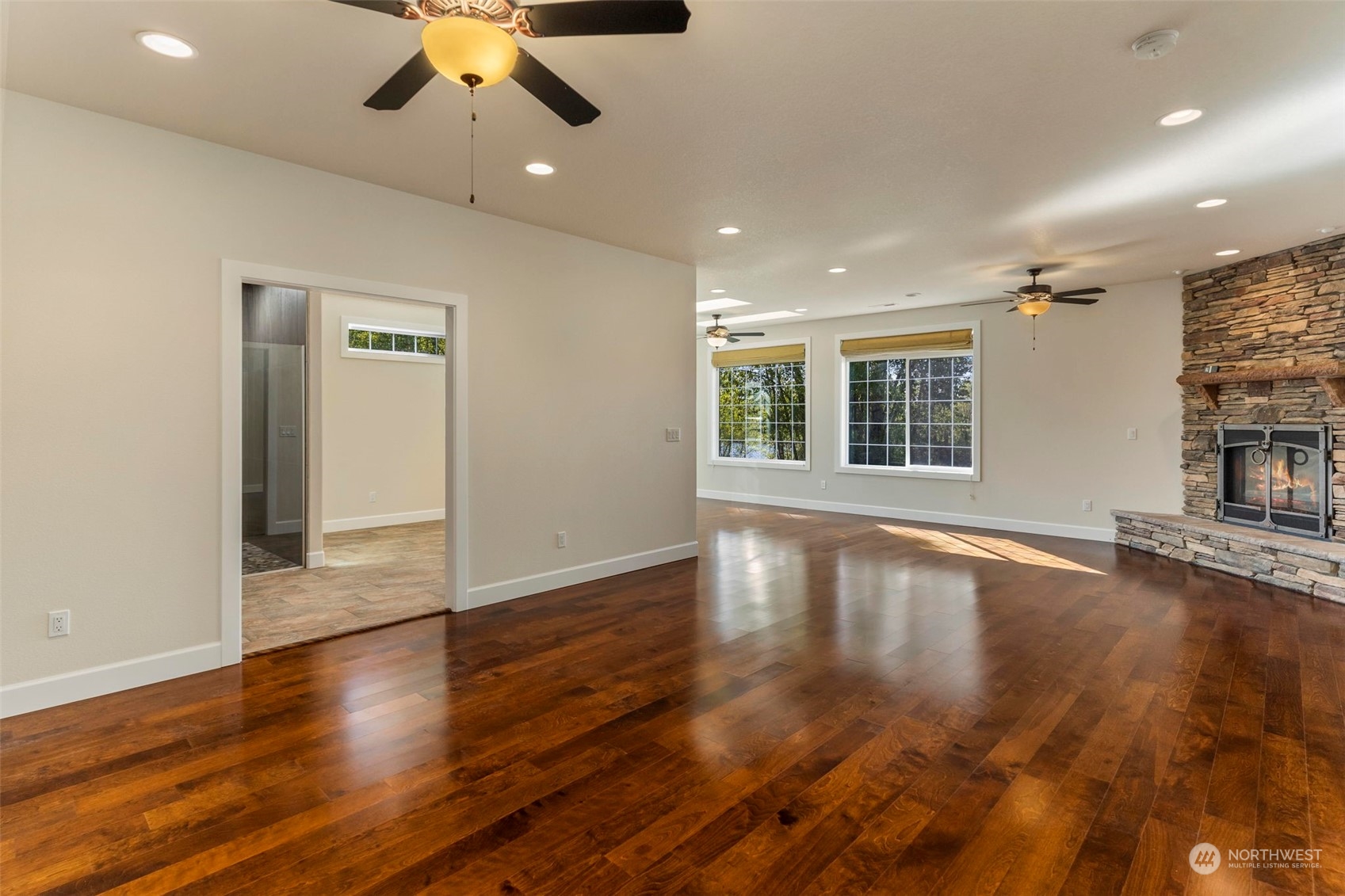 191 Collins Road Toledo, WA 98591 - Photo 13 of 40 a view of an empty room with wooden floor and a window