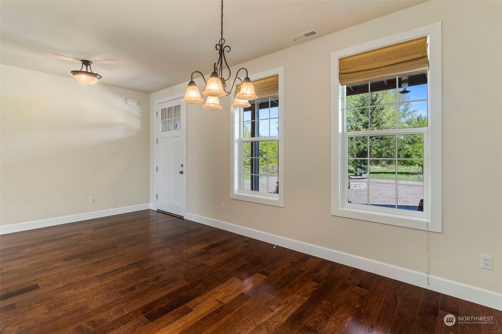 191 Collins Road Toledo, WA 98591 - Photo 4 of 40 a view of a room with wooden floors chandelier and windows
