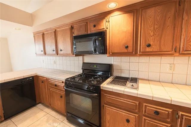 a large kitchen with a wooden cabinets and a stove top oven