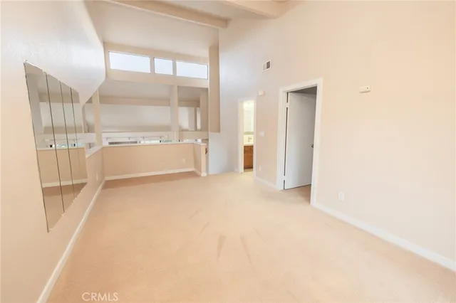 an empty room with windows and city view