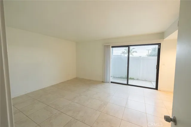 an empty room with sliding glass door