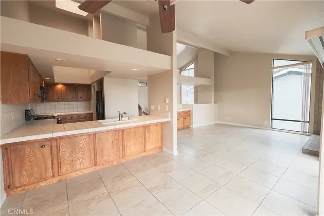 a kitchen with stainless steel appliances kitchen island granite countertop a sink and a white cabinets
