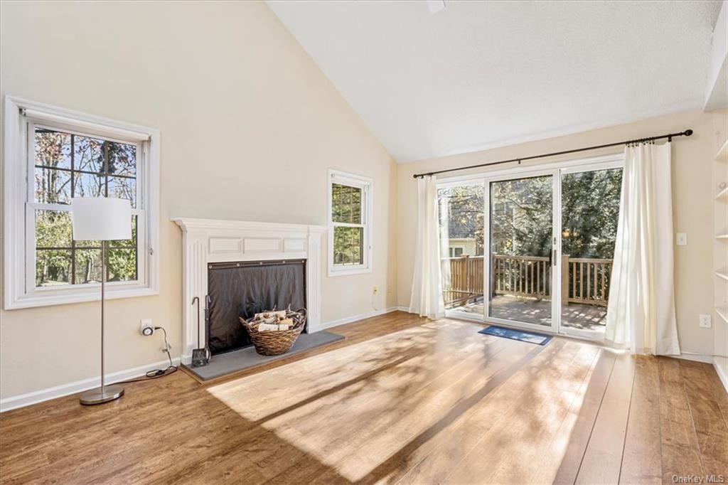 1 Chadwick Court Fishkill, NY 12524 - Photo 12 of 35 Unfurnished living room with high vaulted ceiling, wood-type flooring, and a healthy amount of sunlight