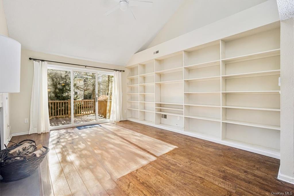 1 Chadwick Court Fishkill, NY 12524 - Photo 15 of 35 Unfurnished living room featuring hardwood / wood-style flooring, ceiling fan, and lofted ceiling