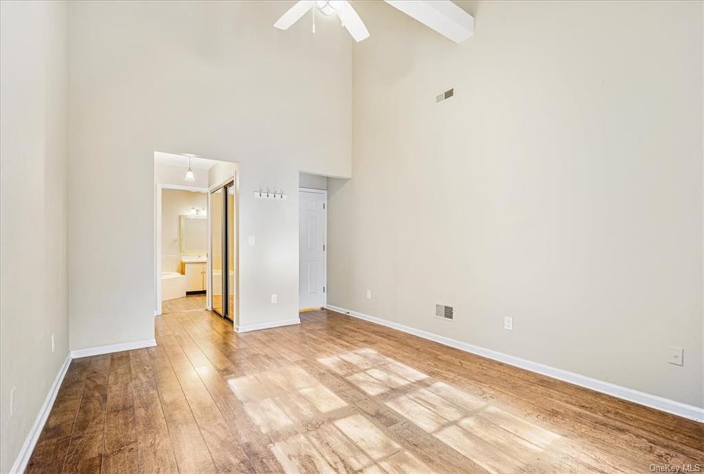 1 Chadwick Court Fishkill, NY 12524 - Photo 21 of 35 Empty room with a towering ceiling, ceiling fan, and light wood-type flooring