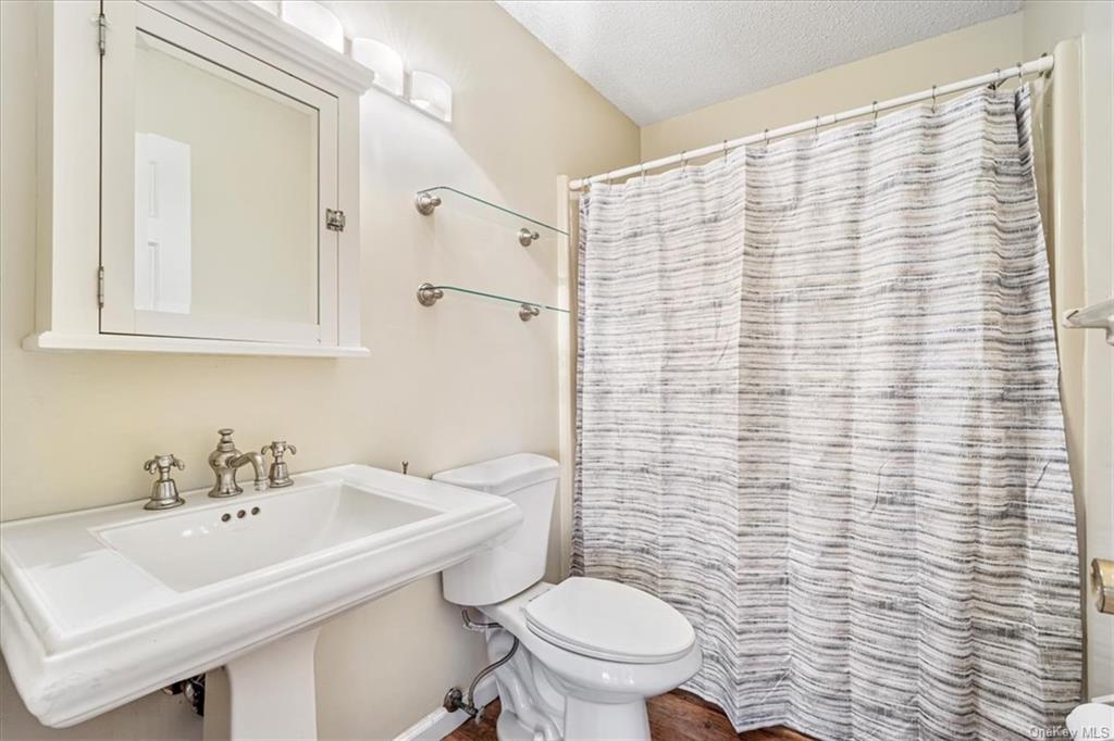 1 Chadwick Court Fishkill, NY 12524 - Photo 25 of 35 Bathroom with a shower with shower curtain, a textured ceiling, toilet, and sink
