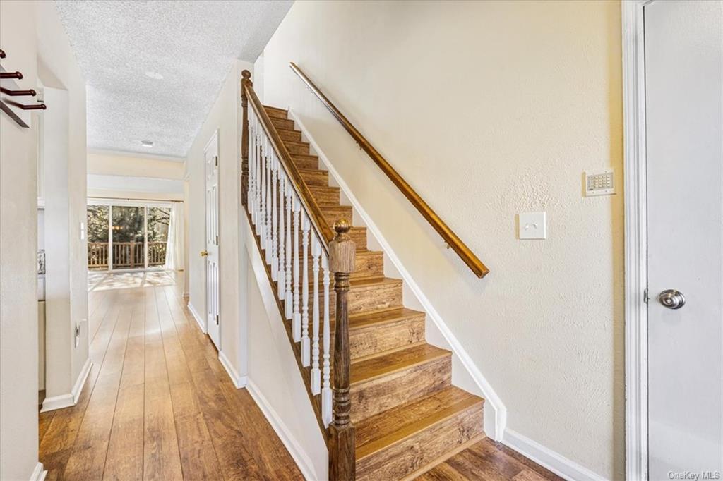 1 Chadwick Court Fishkill, NY 12524 - Photo 4 of 35 Stairway with wood-type flooring and a textured ceiling