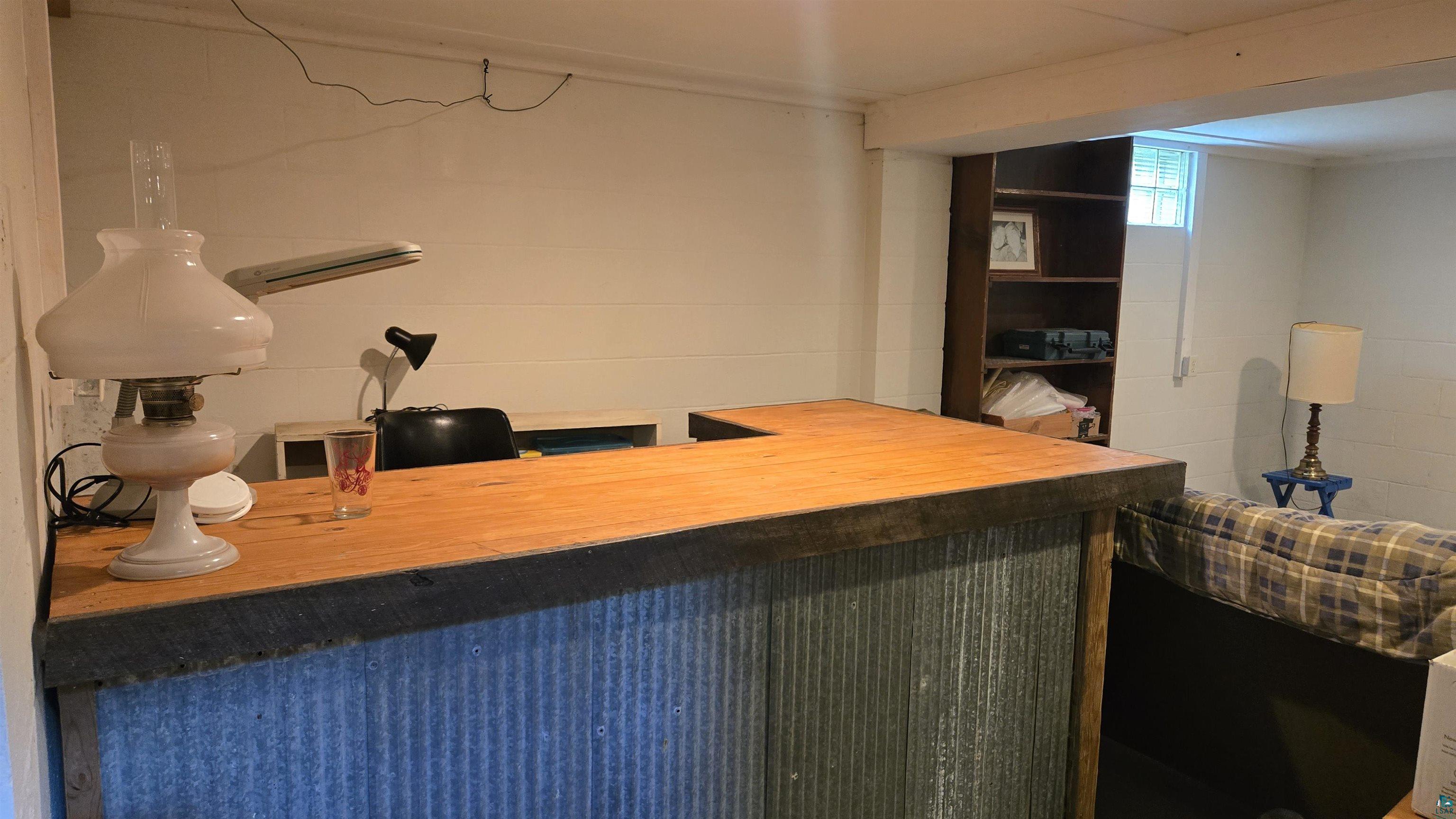10614 Moose Lake Road Orr, MN 55771 - Photo 30 of 44 Custom-built bar featuring a wood-finish countertop and corrugated metal paneling