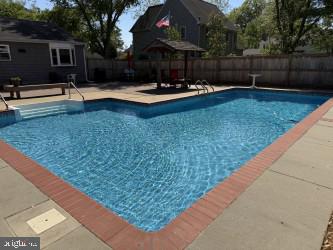 8 Shawnee Road Cambridge, MD 21613 - Photo 3 of 5 a view of swimming pool with outdoor seating and yard