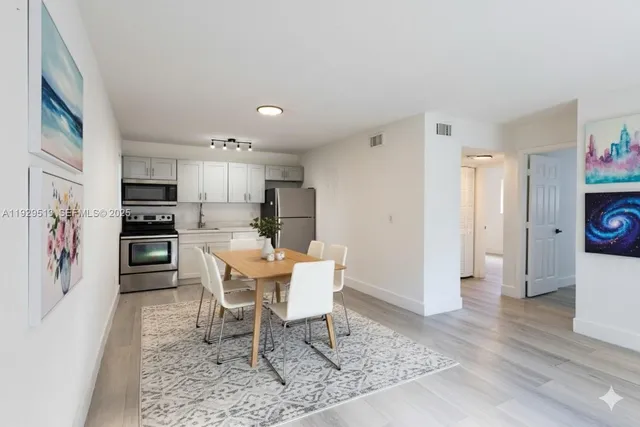 a view of kitchen with microwave and cabinets