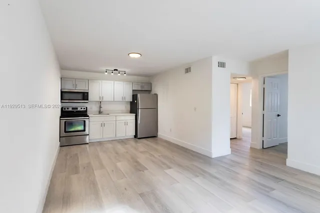 a kitchen with stainless steel appliances a refrigerator and a oven