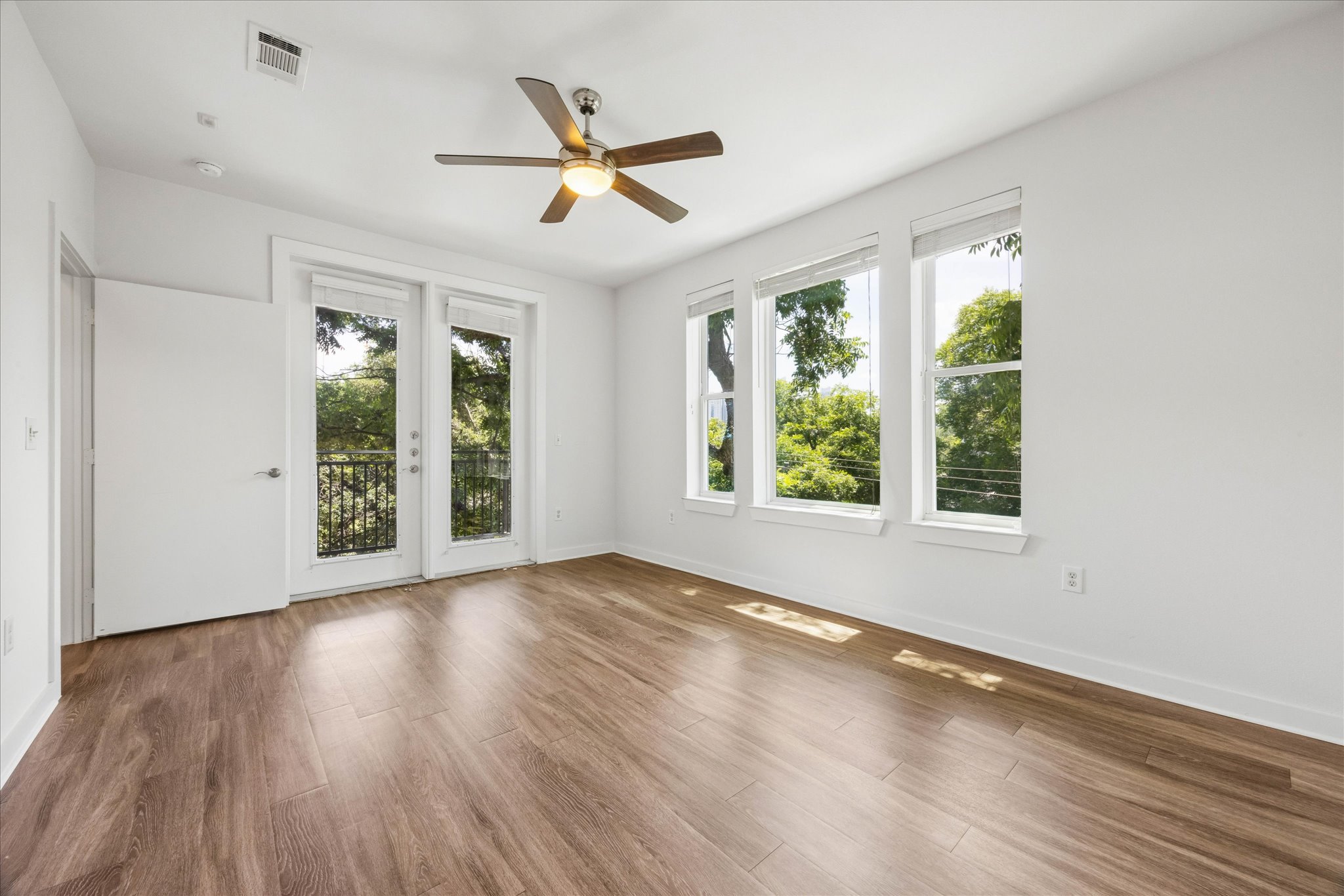 1900 Barton Springs Road, Unit 4041 Austin, TX 78704 - Photo 13 of 35 Hardwood floors and a private balcony offer tranquil treetop views.