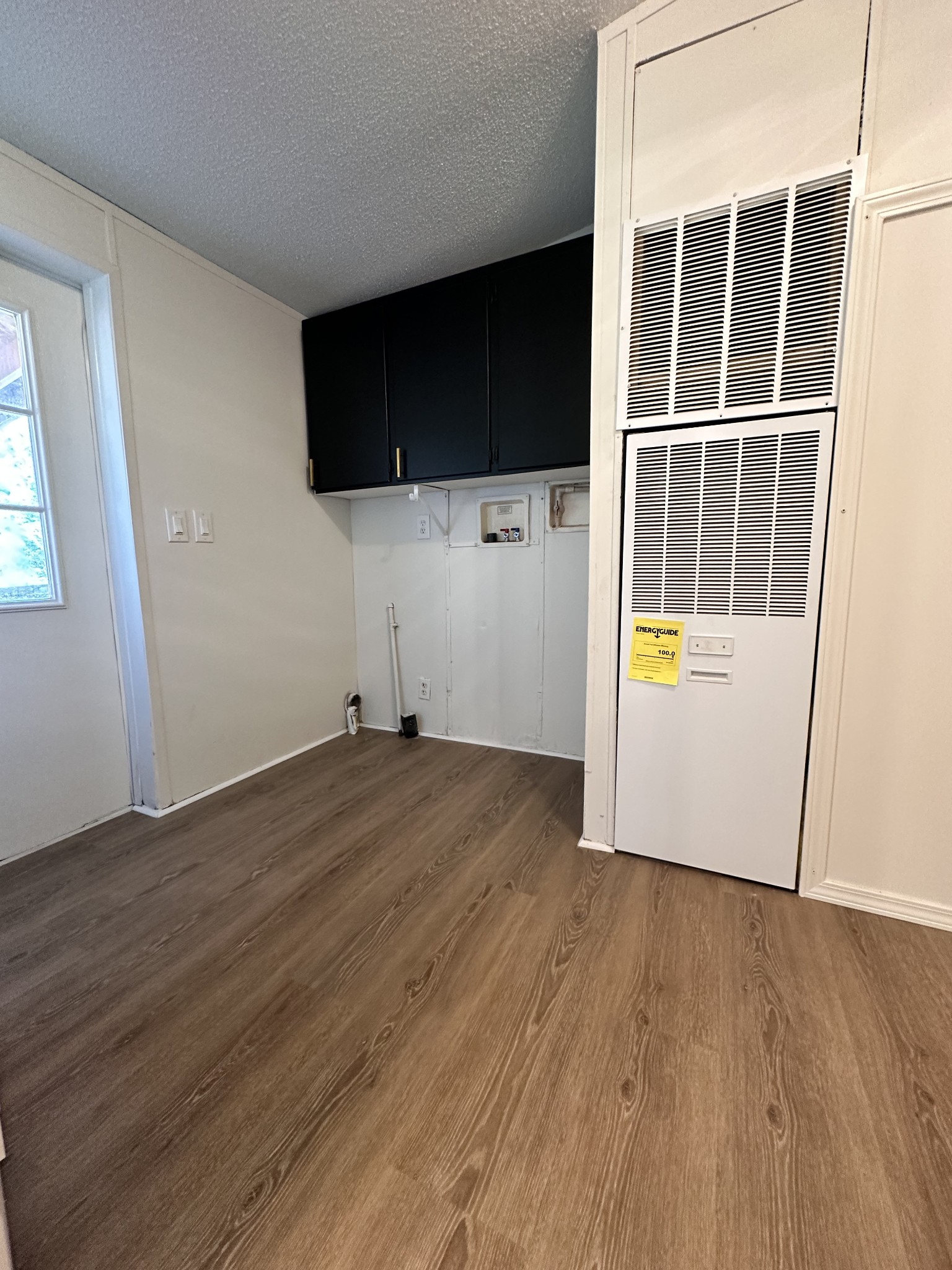 7287 Pinewood Road Nunnelly, TN 37137 - Photo 13 of 18 an empty room with wooden floor and cabinet