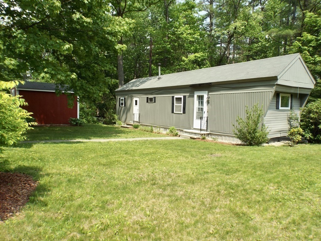 9 Bray Road Buckland, MA 01370 - Photo 21 of 25 a backyard of a house with large trees and plants