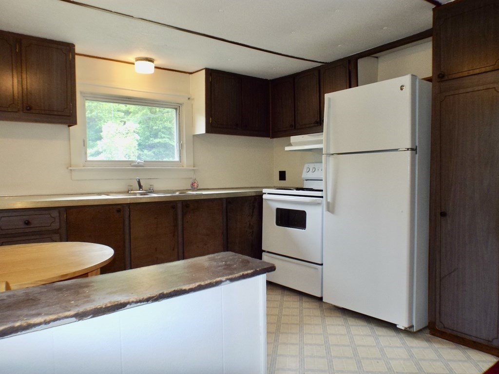 9 Bray Road Buckland, MA 01370 - Photo 9 of 25 a kitchen with granite countertop a sink a refrigerator and a stove