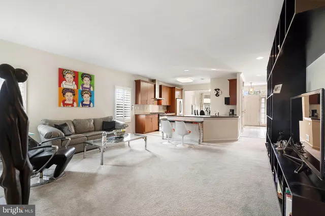 a living room with furniture and large windows