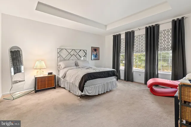 a bathroom with a sink a toilet a mirror and a shower