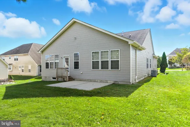a view of a street with flower plants and wooden fence