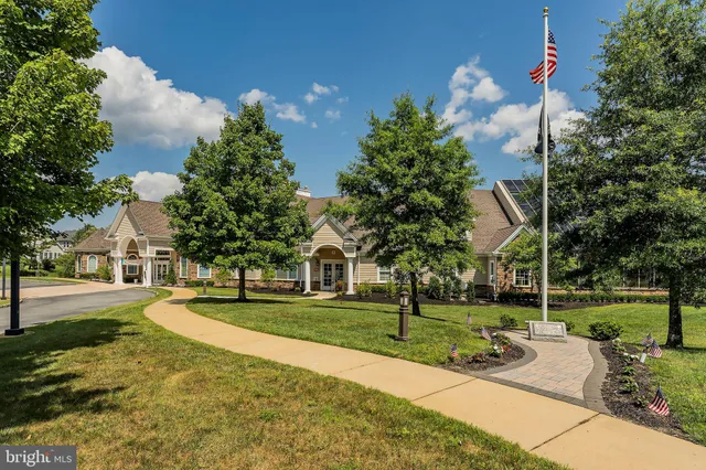a front view of a house with a garden and balcony
