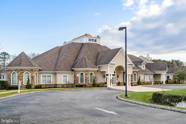 a view of a livingroom with furniture fireplace and wooden floor