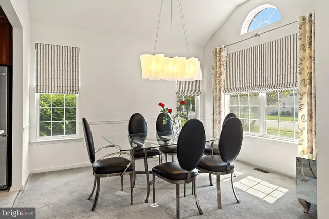 a view of a dining room with furniture and a window