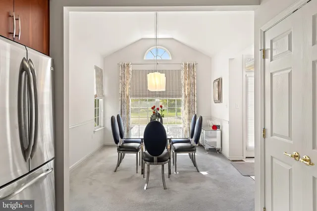 a view of a dining room with furniture and a chandelier