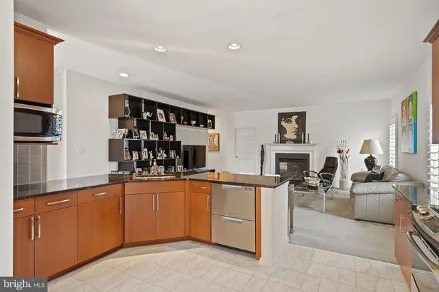 a kitchen with stainless steel appliances granite countertop a sink and cabinets